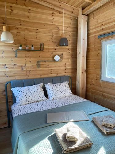 a bedroom with a bed in a wooden wall at Villa Haris in Sarti