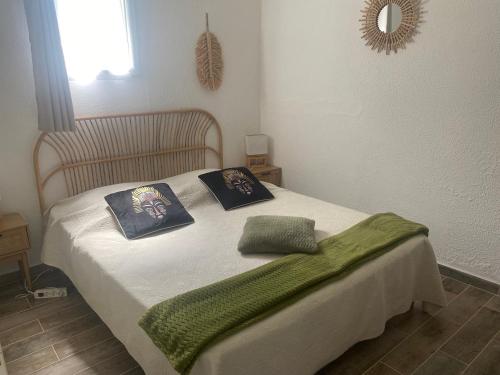a bedroom with a bed with two pillows on it at Gîtes Le Mas du Vieux Chêne in Salavas
