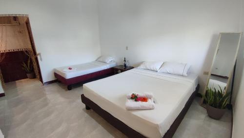 a bedroom with two beds and a tub in it at Kanus Ayangue in Ayangue