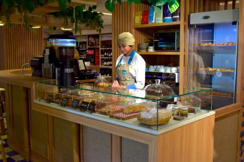 a chef standing behind a counter in a bakery at Zuana Beach Resort in Santa Marta