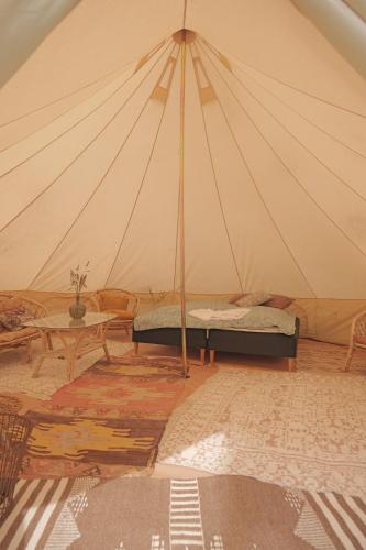 a room with a tent with a bed and a table at Huset i Hejls in Hejls