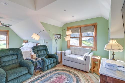a bedroom with a bed and a chair and a couch at Shared Dock and Fire Pit Peaceful Surry Studio! in Surry