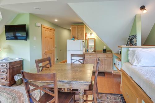 a kitchen and dining room with a table and a bed at Shared Dock and Fire Pit Peaceful Surry Studio! in Surry