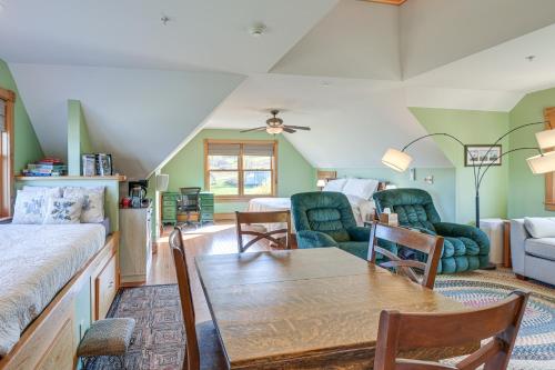 a living room with a bed and a table and chairs at Shared Dock and Fire Pit Peaceful Surry Studio! in Surry