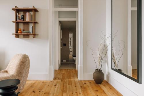 a living room with a chair and a vase on the floor at Ando Living - Corpo Santo House in Lisbon