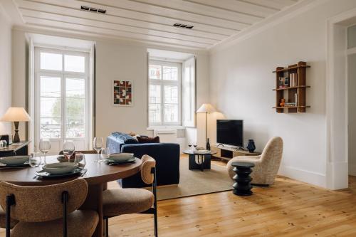 a living room with a table and a couch at Ando Living - Corpo Santo House in Lisbon