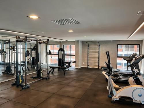a gym with treadmills and machines in a room at Residencial Loft - Studio -407 in Maceió
