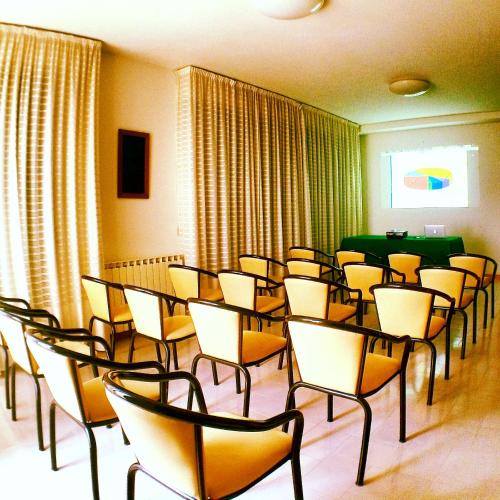 a room with rows of chairs and a table at Hotel Del Buono Wellness & Medical Spa in Chianciano Terme