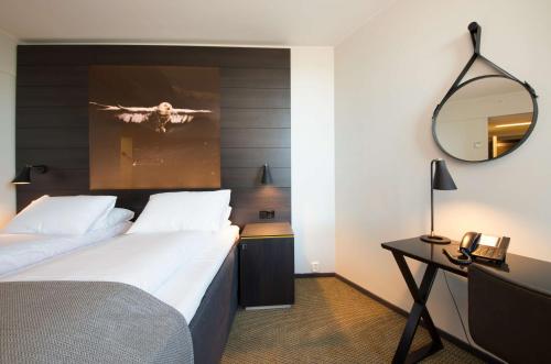 a hotel room with two beds and a mirror at Scandic Ørnen in Bergen