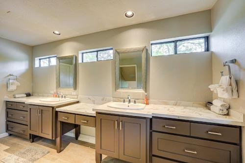 a bathroom with two sinks and two mirrors at Waterfront Seguin Lake House Near Downtown in Seguin