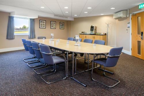 a conference room with a large table and chairs at Holiday Inn Express London - Epsom Downs by IHG in Epsom