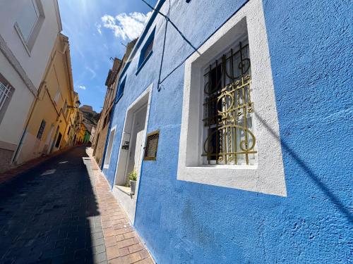 a blue building with a window on a street at Aer Rural Apartment - Casillas Valle de Ayora in Jalance