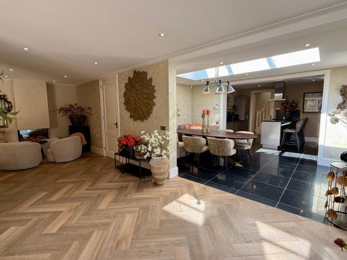 a living room with a kitchen and a dining room at Vakantiewoning Casa Bergen Home in Bergen