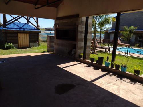 a shadow of a house with a patio with plants at Cabañas y Bungalow " La Comarca" in Concepción del Uruguay