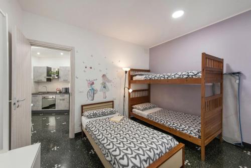two bunk beds in a room with a kitchen at Domus Superba - Genova in Genova