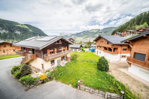 an aerial view of a house with mountains in the background at La Flèche d'Or in Châtel