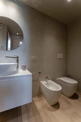 a bathroom with a sink and a toilet and a mirror at Blu Suite in Pontedera