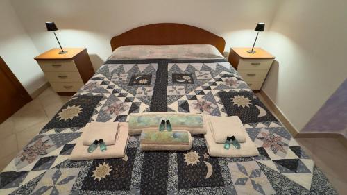 a bedroom with a bed with a quilt on it at Centro Storico Pietragalla in Pietragalla
