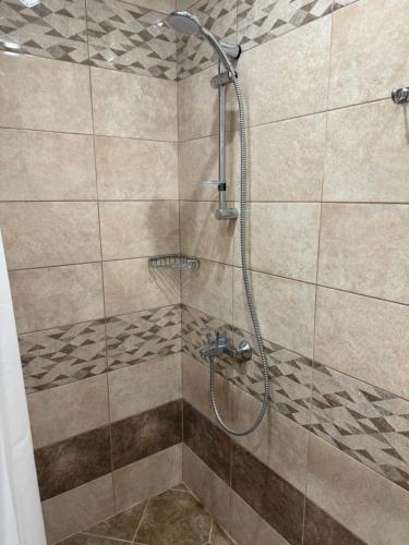 a shower stall with a glass door in a bathroom at Lozenetz Beach Apartments in Lozenets