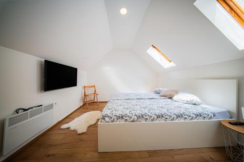 a bedroom with a bed and a flat screen tv at Flexible SelfCheckIns 172 - Zagreb - Center - New in Zagreb