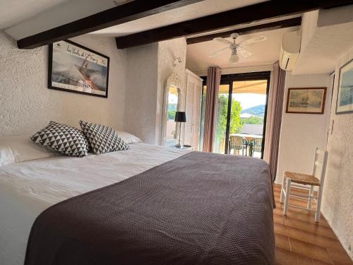 une chambre avec un grand lit avec des oreillers dessus dans l'établissement BELLEVUE HÉRACLÉE, à Saint-Tropez