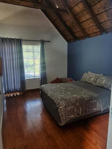a bedroom with a bed and a large window at Charming Loft-Style Appartment in Sandton