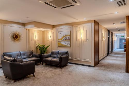 a lobby with couches and chairs in a building at HUSMA Hotel & Spa in Tashkent