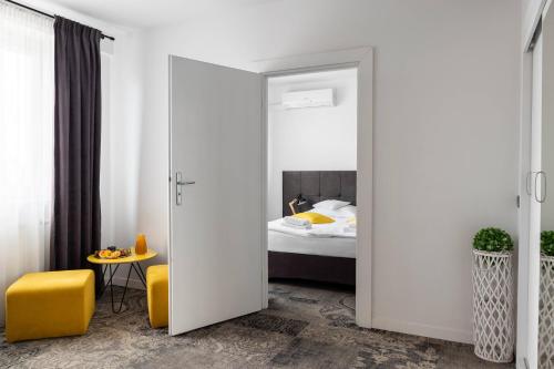 a bedroom with a door leading to a bed at Hotel Nafta Krosno in Krosno
