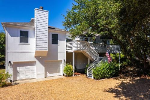 a white house with a staircase in front of it at Dog Friendly Hot Tub Walk to Beach in Southern Shores