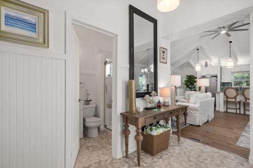 a living room with a table and a living room at Dog Friendly Hot Tub Walk to Beach in Southern Shores