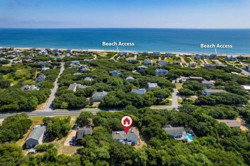 an aerial view of a neighborhood with houses and the ocean at Dog Friendly Hot Tub Walk to Beach in Southern Shores