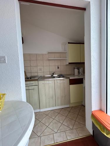 a small kitchen with a sink and a counter at Apartments Marina in Vrsar