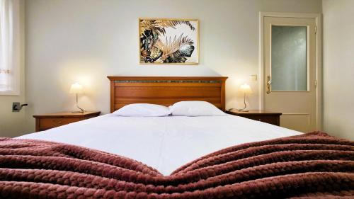 a bedroom with a bed with a heart shaped blanket at Amorosa Beach Apartment Family in Viana do Castelo