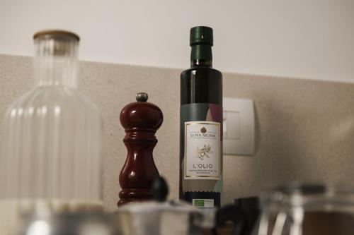 a bottle of wine sitting next to a bottle of alcohol at Luna Minoica Suites and Apartments in Montallegro