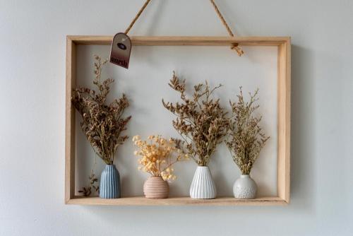 a wooden shelf with vases on a wall at Modern Double Room with Broadband, Private TV and seating area - Room 1 in Solihull