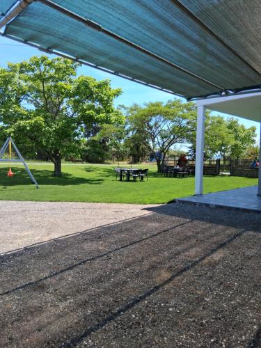 a pavilion with a picnic table in a park at Melissan Escape in Mélissa