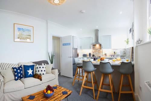 a living room with a white couch and a kitchen at Bay View - Amazing Location dog friendly in Scarborough