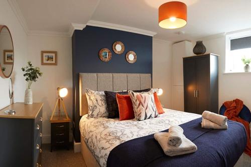 a bedroom with a large bed with towels on it at Bay View - Amazing Location dog friendly in Scarborough