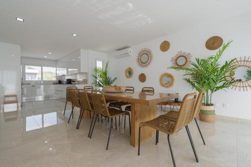 a dining room with a wooden table and chairs at Beach Villa with ocean view in Lourinhã