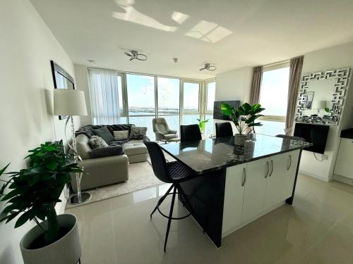 a living room with a table and a couch at Luxury Waterfront Apartment With Panoramic View in Cardiff