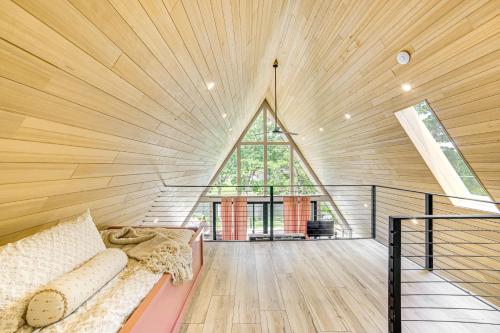 a room with a large window in a wooden ceiling at A-Frame Cabin with Deck Near Cedar Creek Lake in Malakoff