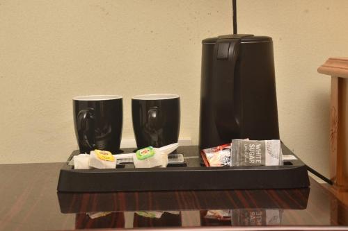 a tray with two cups on a table at Crown Hotel Juba in Juba