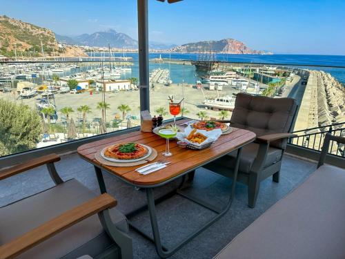 a table with food and drinks on a balcony at Ada Port Hotel Adults Only in Alanya