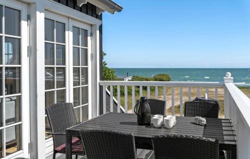 a table on a balcony with a view of the ocean at Apartment Klint Strandvej Nykøbing Sj Vi in Højby