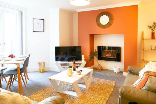 a living room with an orange wall at The Court Yard Apartment - Fantastic location! in Scarborough