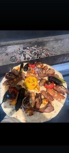a pizza sitting on top of a table at Vələs Garden in Quba