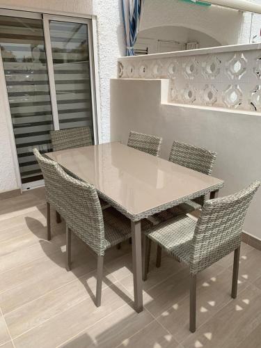 a dining table and chairs on a patio at Chaleureux Duplex refait a neuf in Torrevieja