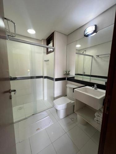 a bathroom with a toilet and a sink and a shower at Kariri Beach Residence in Caucaia