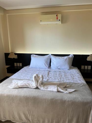 a bed with two white towels on it at Kariri Beach Residence in Caucaia