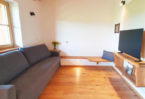 a living room with a couch and a flat screen tv at Springerhof in Schechen